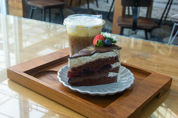Coffee and chocolate cake with ice coffee in coffee shop.