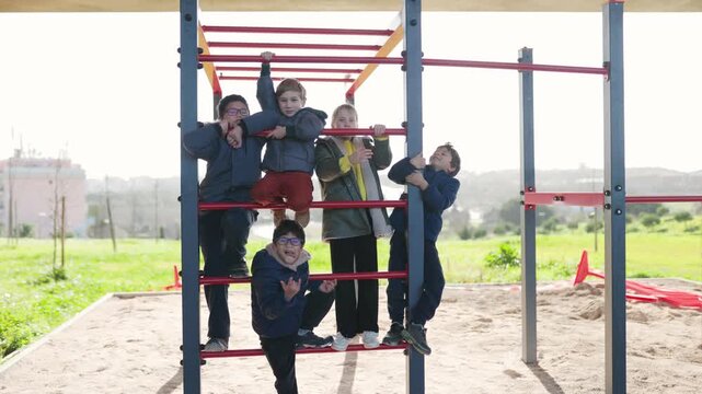 Happy children climbing on playground monkey bars
