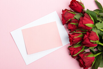 Beautiful and festive celebration background with roses, present and card for valentines day celebration or birthday wishes romantic in red and pink