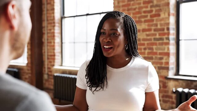 Woman in white shirt talking to man