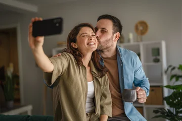 Fototapete Altes Krankenhaus Beelitz Happy loving couple taking selfie at home  © Miljan Živković