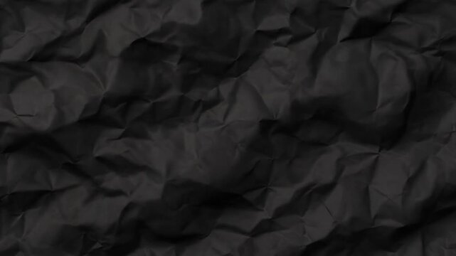 Dark crumpled paper texture seamless wrinkled black background
