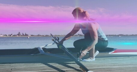 Kneeling rower adjusting single scull riggers on dock at lakeside, wearing tank top, copy space © vectorfusionart