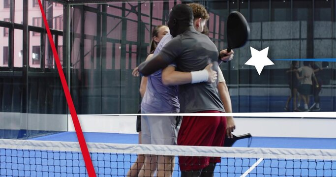 Embracing four racket players in sportswear sharing postmatch hug at net on blue court, with paddle