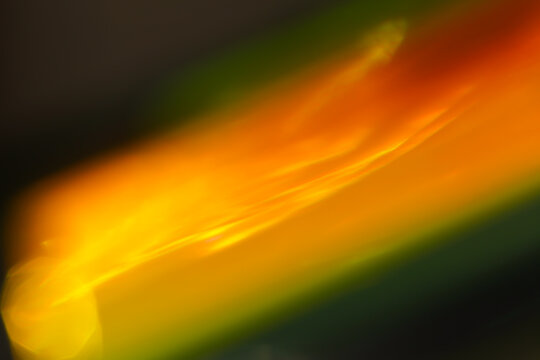 prism light refraction and neon light streaks.Abstract Orange and Green Gradient Blur.