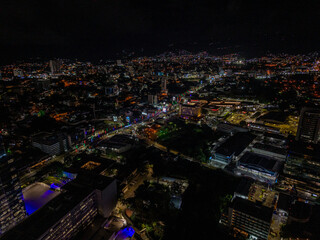 Obraz premium Beautiful aerial view of Tegucigalpa at night, capital of Honduras, surrounded by mountains, city lights glowing across the urban valley