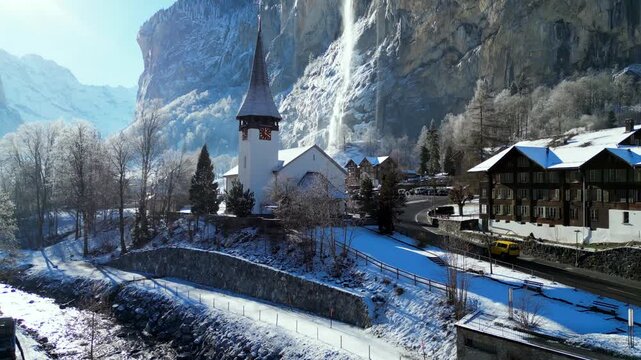 Church in Lauterbrunnen Valley with Waterfalls and Snowy Mountains, Switzerland