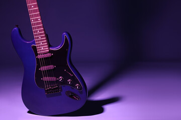 Obraz premium Modern electric guitar on purple background