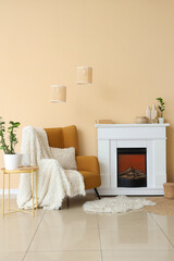 Obraz premium Fireplace and armchair near beige wall in interior of room