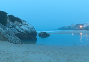 Serene Beach at Dusk with Rocks.