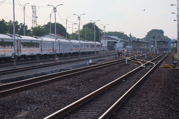 Fototapeta premium Train passing through multiple railway tracks at station area