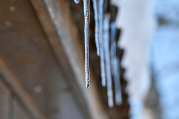 Icicles Hanging from Roof Edge in Winter