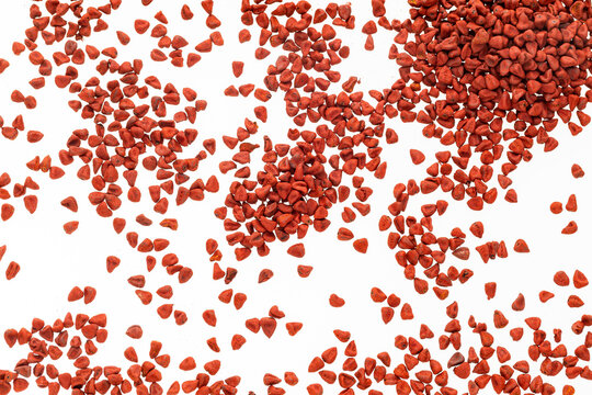 Bixa Orellana - Pile of red organic annatto seeds.