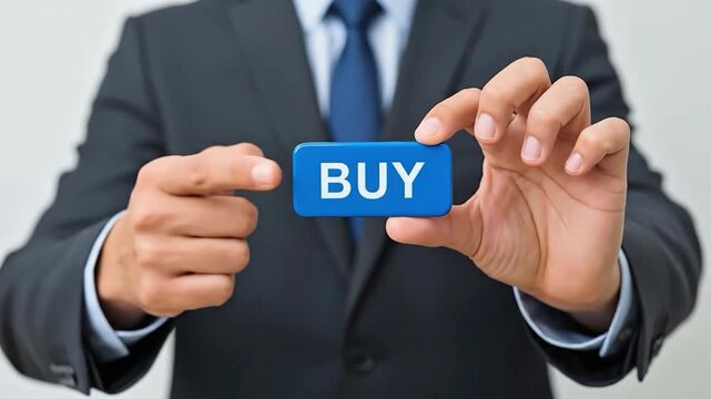 Businessman holding blue button with word BUY encouraging purchase decision making and consumer choice in retail and e-commerce