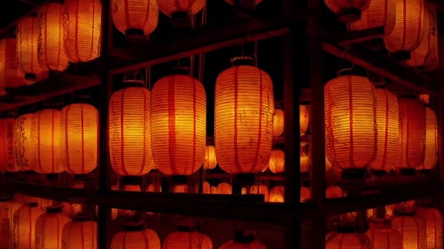 Chinese lunar new year holiday celebration. Spring festival tradition. Chunjie. Asia. A collection of illuminated paper lanterns, predominantly in shades of orange and red.