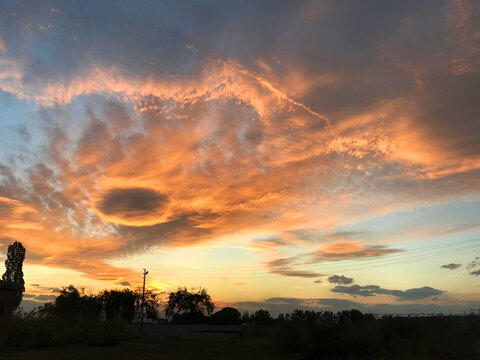 Eye in the sky and orange clouds in sunset at city of Van, Turkey.
