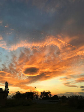 Eye in the sky and orange clouds in sunset at city of Van, Turkey.