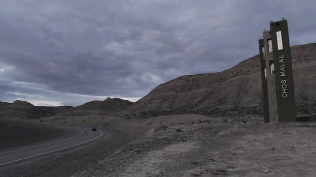 Desolate Road and Welcome Sign in Patagonia, Chos Malal, Argentina