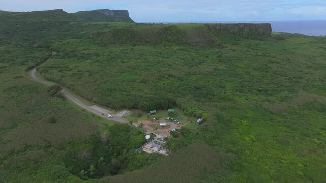 Discover the mesmerizing 'Grotto Blue.' This aerial footage captures The Grotto in Northern Saipan, a world-renowned collapsed limestone cavern and a premier destination for scuba divers. The video sh
