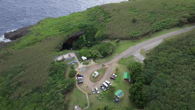 Discover the mesmerizing 'Grotto Blue.' This aerial footage captures The Grotto in Northern Saipan, a world-renowned collapsed limestone cavern and a premier destination for scuba divers. The video sh