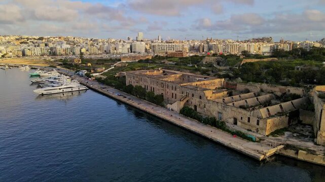 Aerial view of abandoned Lazzaretto buildings along the waterfront on Manoel Island, Malta.