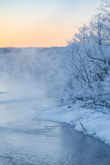 Fototapeta premium Frost-covered Trees and River Fog at Otowa Bridge in Tsurui Village, Winter Morning, Hokkaido, Japan