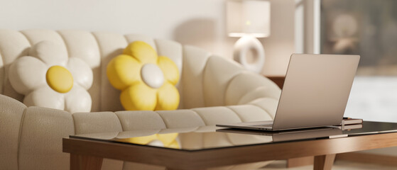 Laptop on glass top table aside white pumpkin sofa and yellow flower cushion in a modern living room