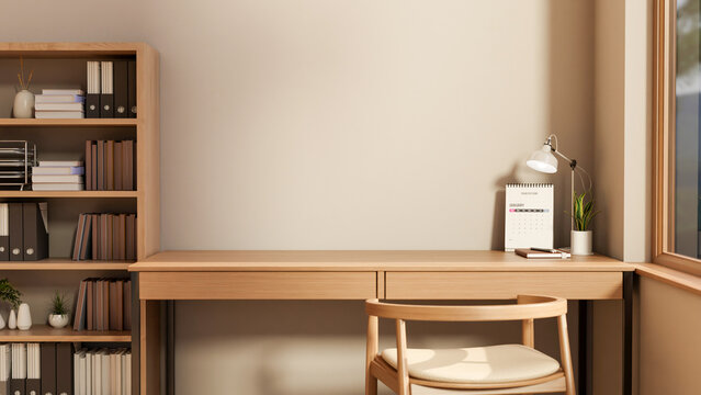 Calendar and lamp with plant pot on wooden table and chair aside bookshelf and window in room corner