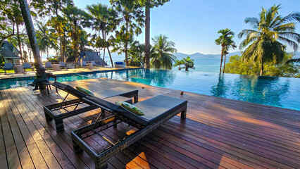 Fototapeta premium Relaxing poolside retreat overlooking the serene waters of Koh Phayam Island in Thailand