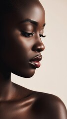 Close-up of elegant black woman's face on isolated cream background.