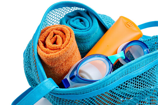 Blue mesh beach bag filled with colorful towels swimming goggles and sunscreen bottle isolated on a white background representing summer holiday vacation travel