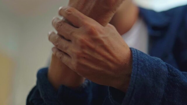 Asian Man Suffering from Wrist Pain