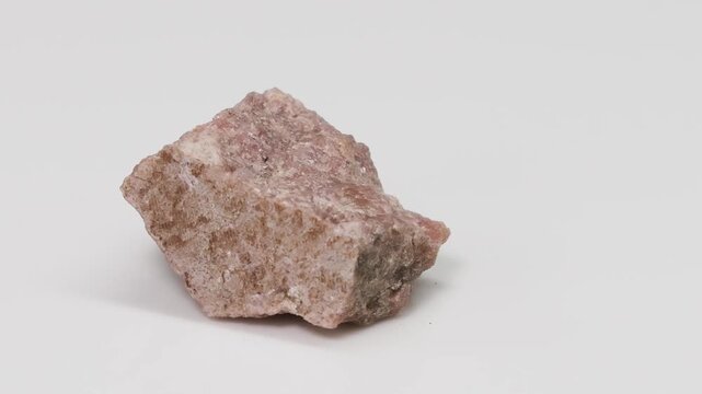 Close Up View of Rotating Pink Epidosite Mineral Specimen on White
