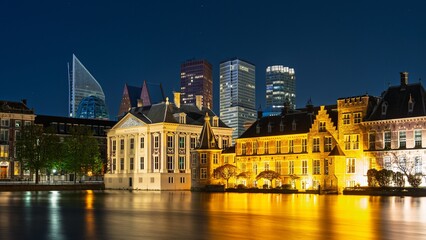 Explore The Hague s beautiful nightscape, where historic Binnenhof meets modern towers, reflected...