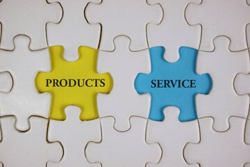 Fototapeta premium Yellow 'PRODUCTS' and blue 'SERVICE' puzzle pieces symbolize collaboration and integration.