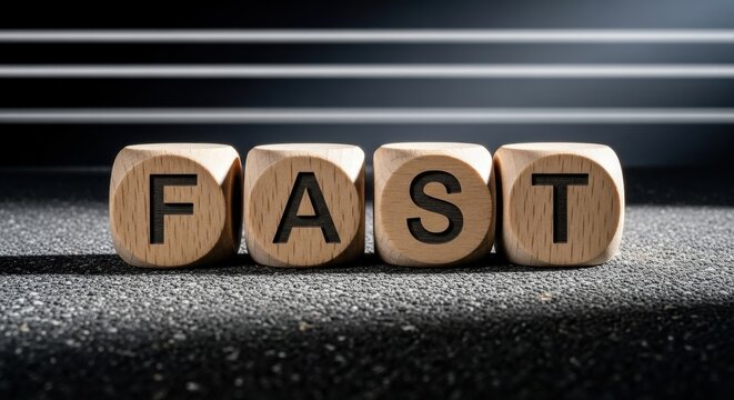 Wooden Blocks Spelling Out the Word FAST on a Textured Surface.