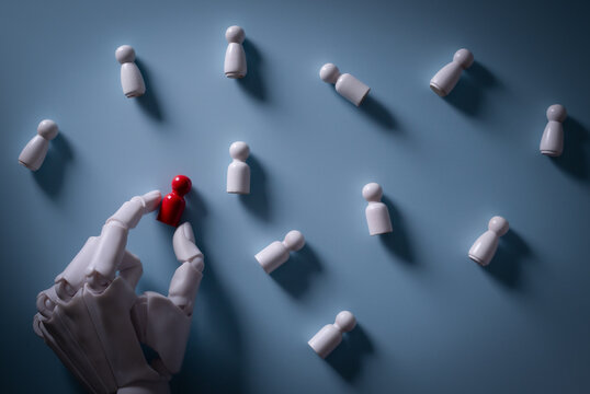 AI Robotic Hand Selecting Red Peg Figure for Recruitment Concept