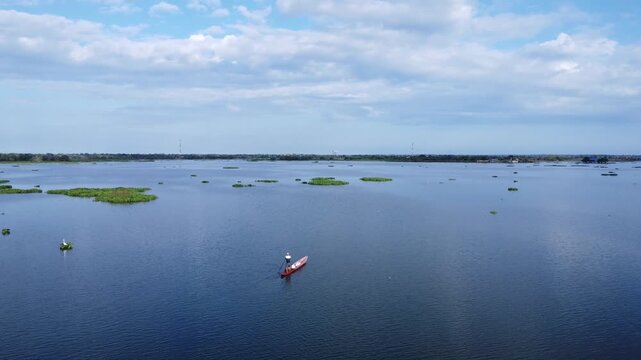 Man Rowing a Canoe on River in Mompox Colombia