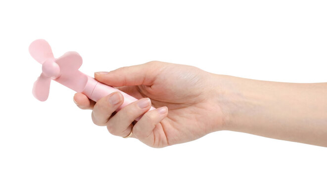 Hand holding small pink portable handheld fan