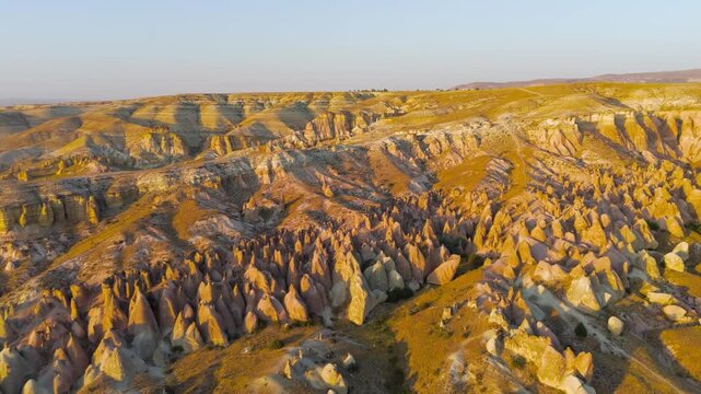 Goreme, Nevsehir, Turkey. Abstract natural art of Devrent Valley with surreal stone formations and mineral colors in evening illumination.. Aerial View, MasterShots, Circle (Far)