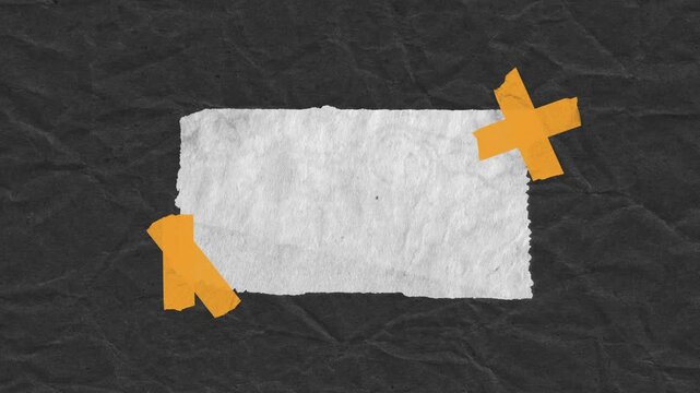 Blank white paper rectangle on black textured background held securely by orange adhesive tape strips