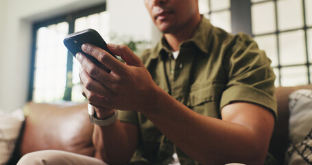 Hands, home and man on sofa, smartphone and message to contact, relax and online reading....
