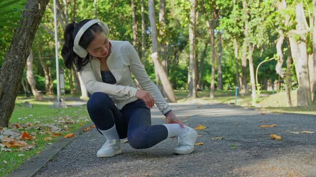 Woman suffering ankle sprain injury during outdoor workout