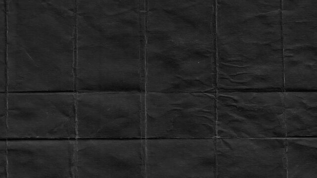 Folded black paper texture revealing creases and detailed folds for a dark and textured background