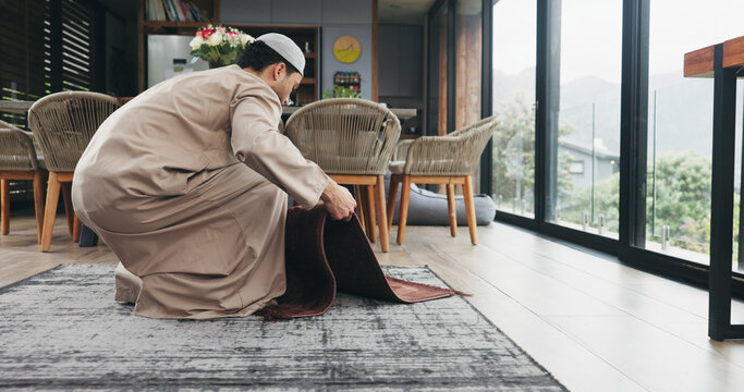 Muslim man, salah and preparation with mat for worship, prayer or islam faith in home. Male person, direction and religion with carpet pointing to qibla for Allah, spiritual connection or praise god