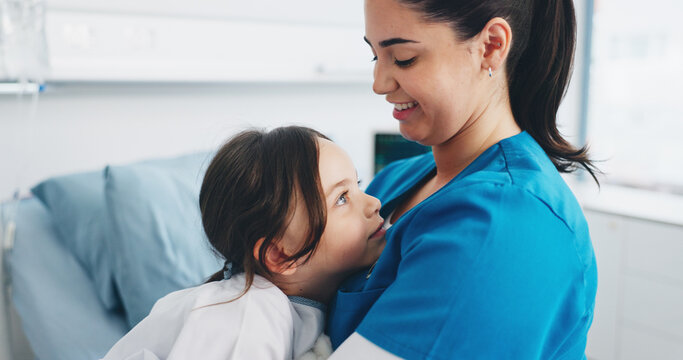 Happy woman, nurse and hug with child patient for health checkup, exam or consultation in clinic. Female person, doctor and support care with smile, girl or kid for medical treatment or appointment