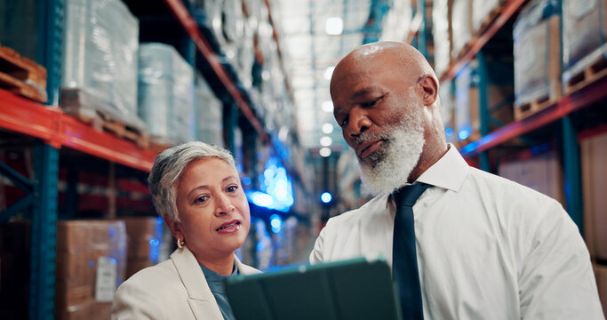 Warehouse, manager and people with tablet, shipping and checking stock distribution schedule on web. Reading, mature man and woman with tech for delivery update, logistics or collaboration in factory