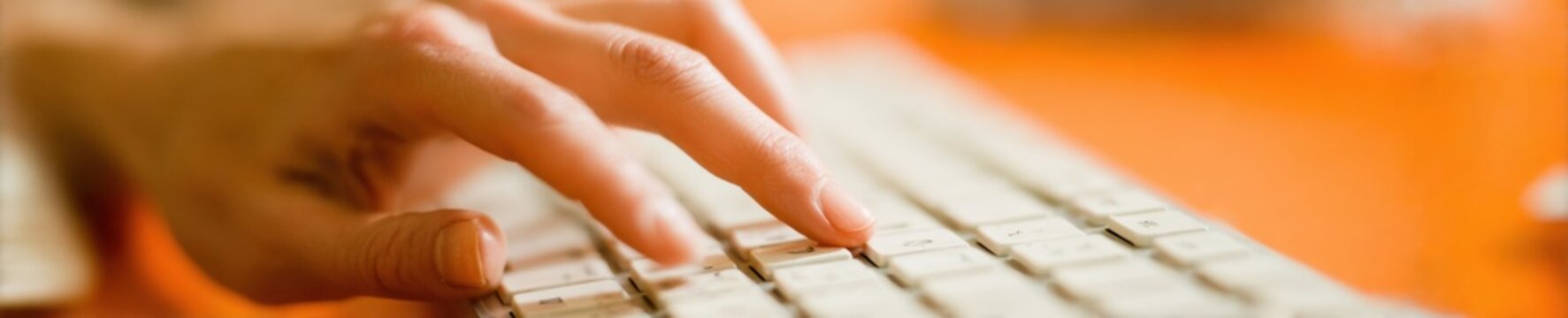 Close up of female finger pressing computer keyboard key in professional office for environmental sustainability go paperless initiative and corporate digital branding