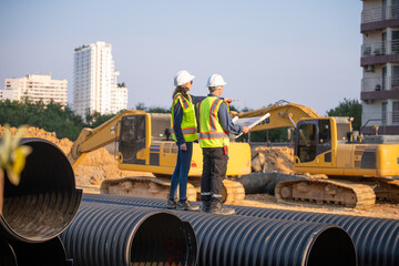 Engineer working Industrial pipeline system used for water supply or electrical cable protection large cylindrical pipes arranged in infrastructure underground utilities and public infrastructure.