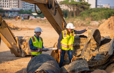 Engineer working Industrial pipeline system used for water supply or electrical cable protection large cylindrical pipes arranged in infrastructure underground utilities and public infrastructure.